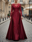 FJØRNA burgundy lace long-sleeve satin A-line gown with a flowing maxi dress design, featuring elegant lace details and a fitted bodice.