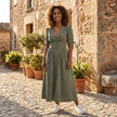 FJØRNA button front midi dress with V-neck and waist tie, featuring a flowing fabric and elegant design.