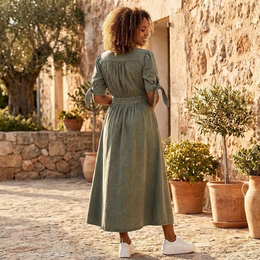 FJØRNA button front midi dress with V-neck and waist tie, showing the elegant dress design and fabric details.