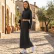 FJØRNA ribbed knit midi dress with long sleeves and high neckline, showcasing a fitted silhouette and textured fabric.