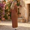 FJØRNA ribbed knit midi dress with long sleeves and high neck, showcasing its fitted silhouette and textured fabric.