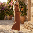 FJØRNA ribbed knit midi dress with long sleeves and high neck, showcasing a fitted, textured design on a neutral background.