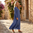 FJØRNA loose fit maxi shirt dress with long sleeves and V-neck, shown on a model in a relaxed, flowing silhouette.
