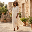 FJØRNA button front maxi shirt dress with waist tie, long sleeves, and a relaxed fit, showcased on a model.