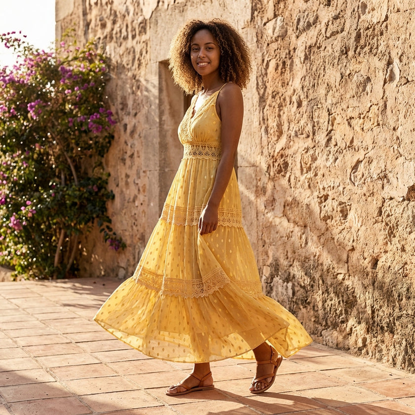 FJØRNA tiered lace maxi dress with V-neck and flowing skirt, shown in a full-length view highlighting its elegant design.