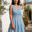 FJØRNA tiered lace maxi dress with V-neck and flowy skirt, showcasing intricate lace details and layered design.