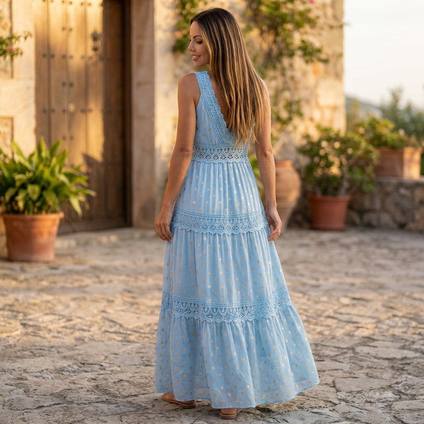 FJØRNA tiered lace maxi dress with V-neck, flowy skirt, and intricate lace details, perfect for elegant occasions.