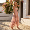FJØRNA tiered lace maxi dress with V-neck and flowy skirt, featuring intricate lace details and elegant silhouette.