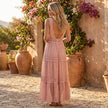 FJØRNA tiered lace maxi dress with V-neck and flowing skirt, shown in a full-length view on a model.