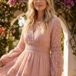 FJØRNA tiered lace maxi dress with V-neck and flowing skirt, featuring intricate lace details and elegant, layered design.