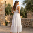 FJØRNA tiered lace maxi dress with v-neck and flowy skirt, featuring intricate lace details and elegant silhouette.
