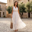 FJØRNA tiered lace maxi dress with V-neck, flowy skirt, and intricate lace details, perfect for elegant occasions.