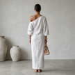 FJØRNA women's summer maxi dress featuring an asymmetric linen design, flowing fabric, and a relaxed fit for warm weather.