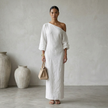 FJØRNA summer maxi dress for women with asymmetric linen design, sleeveless style, and flowing fabric perfect for warm weather.