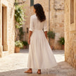 FJØRNA women's summer dress with long sleeves and slit, lightweight and stylish for warm weather, shown on a model.
