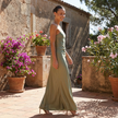 FJØRNA one shoulder satin maxi dress with draped silhouette, featuring smooth fabric and elegant design, shown on a model.