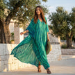 FJØRNA boho printed maxi dress with loose fit and V-neck, featuring colorful patterns and flowing fabric.