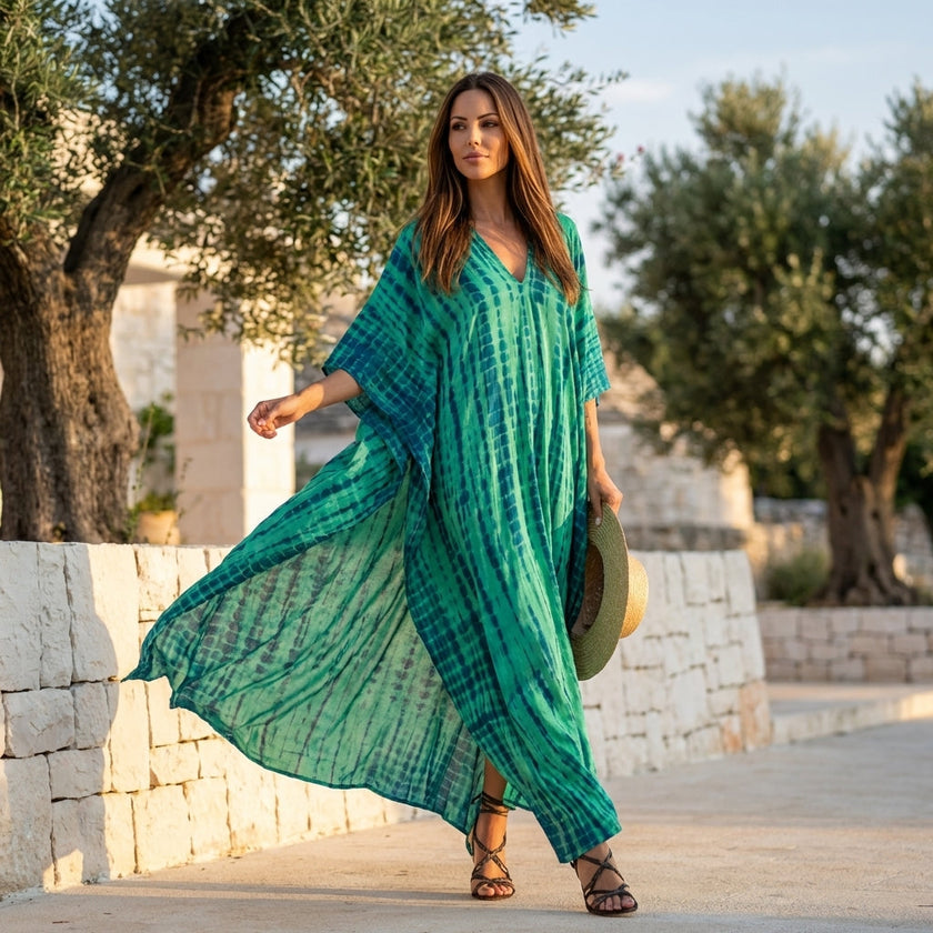 FJØRNA boho printed maxi dress with loose fit and V-neck, featuring colorful patterns and flowing fabric.