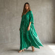 FJØRNA boho printed maxi dress with loose fit and V-neck, featuring vibrant patterns and flowing fabric.