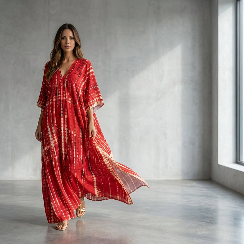 FJØRNA boho printed maxi dress with loose fit and V-neck, featuring vibrant floral patterns and flowing fabric.