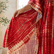 FJØRNA boho printed maxi dress with loose fit and V-neck, features vibrant patterns and flowing fabric.