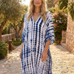 FJØRNA boho printed maxi dress with loose fit and V-neck, featuring vibrant patterns and flowing fabric.