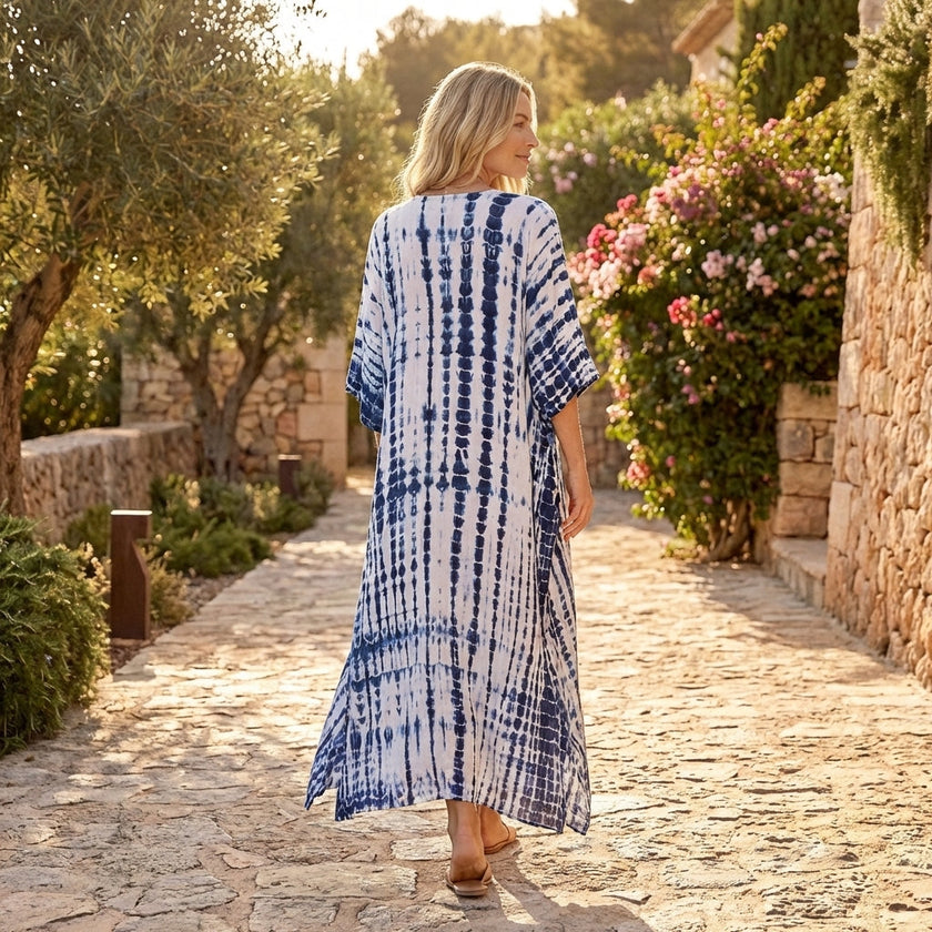 FJØRNA boho printed maxi dress with loose fit and V-neck, featuring vibrant floral patterns and flowing fabric for a relaxed style.