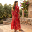 FJØRNA boho printed maxi dress with loose fit and V-neck, featuring colorful patterns and flowing fabric.