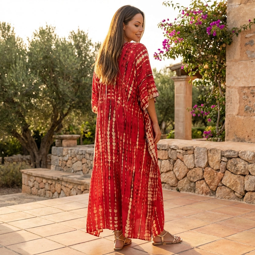 FJØRNA boho printed maxi dress with loose fit and V-neck, featuring colorful patterns and flowing fabric.