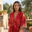 FJØRNA boho printed maxi dress with loose fit and V-neck, featuring vibrant patterns and flowing fabric.