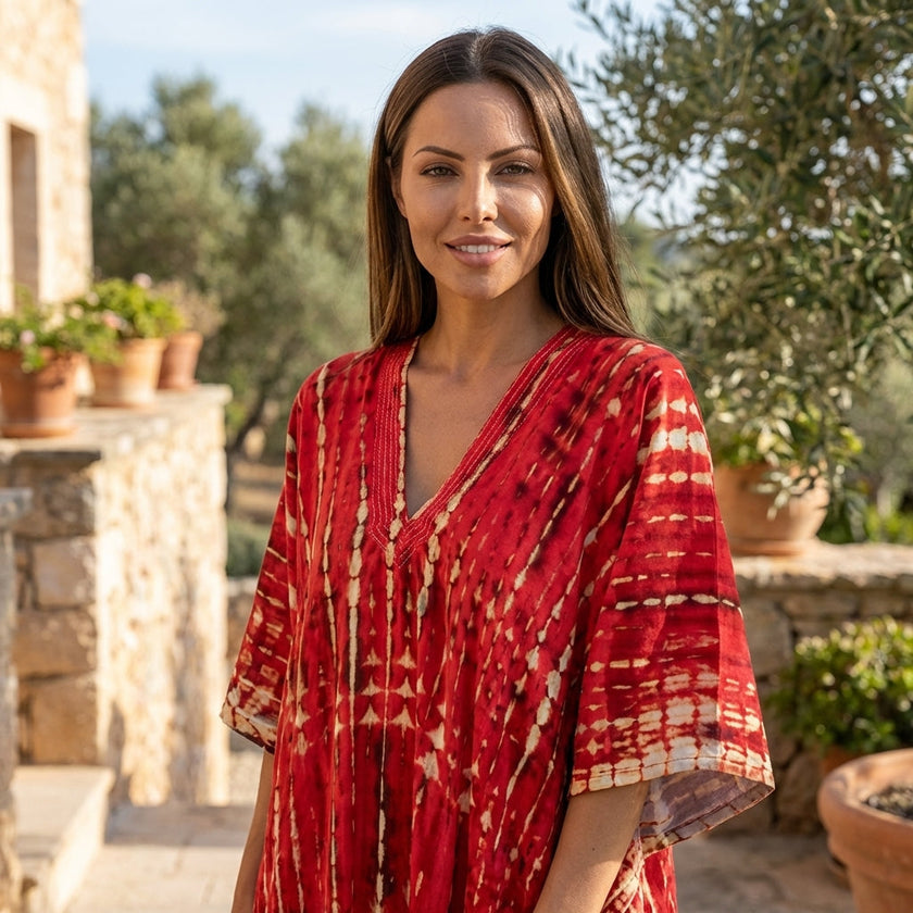 FJØRNA boho printed maxi dress with loose fit and V-neck, featuring vibrant patterns and flowing fabric.