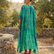 FJØRNA boho printed maxi dress with loose fit and V-neck, flowing fabric, and vibrant bohemian pattern on a model.