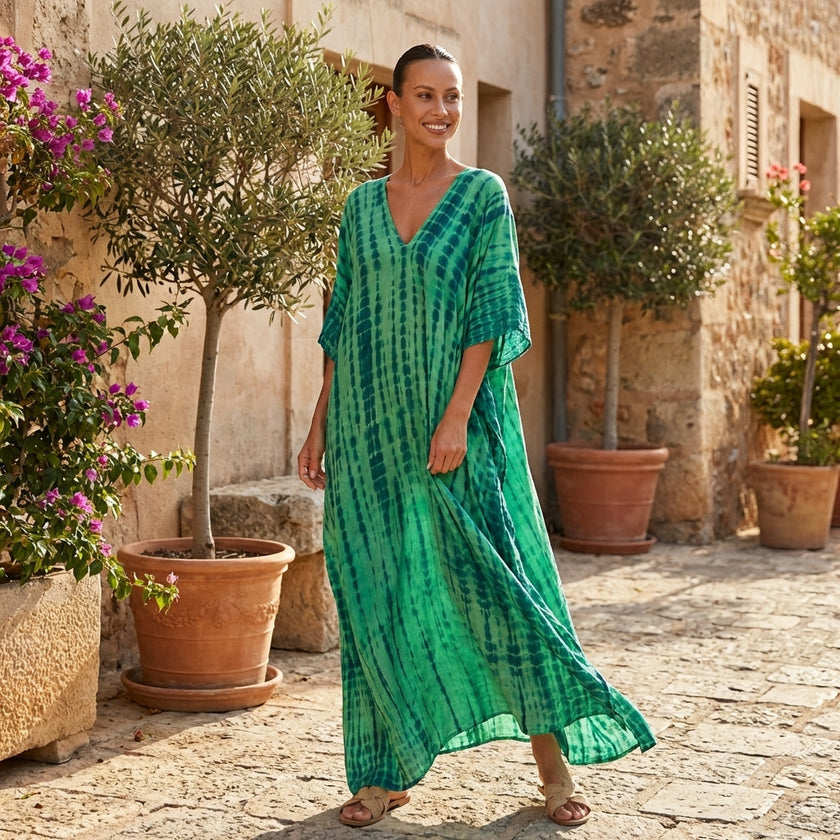 FJØRNA boho printed maxi dress featuring a loose fit and V-neck, flowing fabric with colorful bohemian patterns.