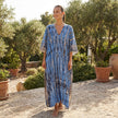 FJØRNA boho printed maxi dress with loose fit and V-neck, featuring colorful patterns and flowing fabric.