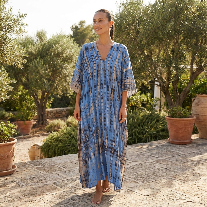 FJØRNA boho printed maxi dress with loose fit and V-neck, featuring colorful patterns and flowing fabric.