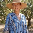 FJØRNA boho printed maxi dress with loose fit and V-neck, featuring colorful patterns and flowing fabric design.