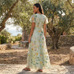 FJØRNA floral chiffon maxi dress with short sleeves and V-neck, flowing and elegant for summer or special occasions.