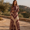 FJØRNA boho printed long sleeve maxi dress with relaxed fit, featuring floral patterns and flowing fabric.
