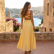 FJØRNA pleated V-neck maxi dress with flowy silhouette and elegant draping, perfect for stylish occasions.