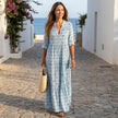 FJØRNA printed long sleeve maxi dress with V-neck and relaxed fit, flowing fabric, and stylish design.