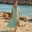 FJØRNA floral V-neck maxi dress with short sleeves, flowy fit, and vibrant floral pattern, perfect for warm-weather wear.