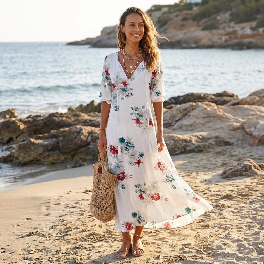 FJØRNA floral V-neck maxi dress with short sleeves, flowing fit, and vibrant flower pattern, perfect for summer or casual occasions.