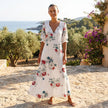 FJØRNA floral V-neck maxi dress with short sleeves, flowy fit, and vibrant floral pattern, perfect for summer or casual wear.
