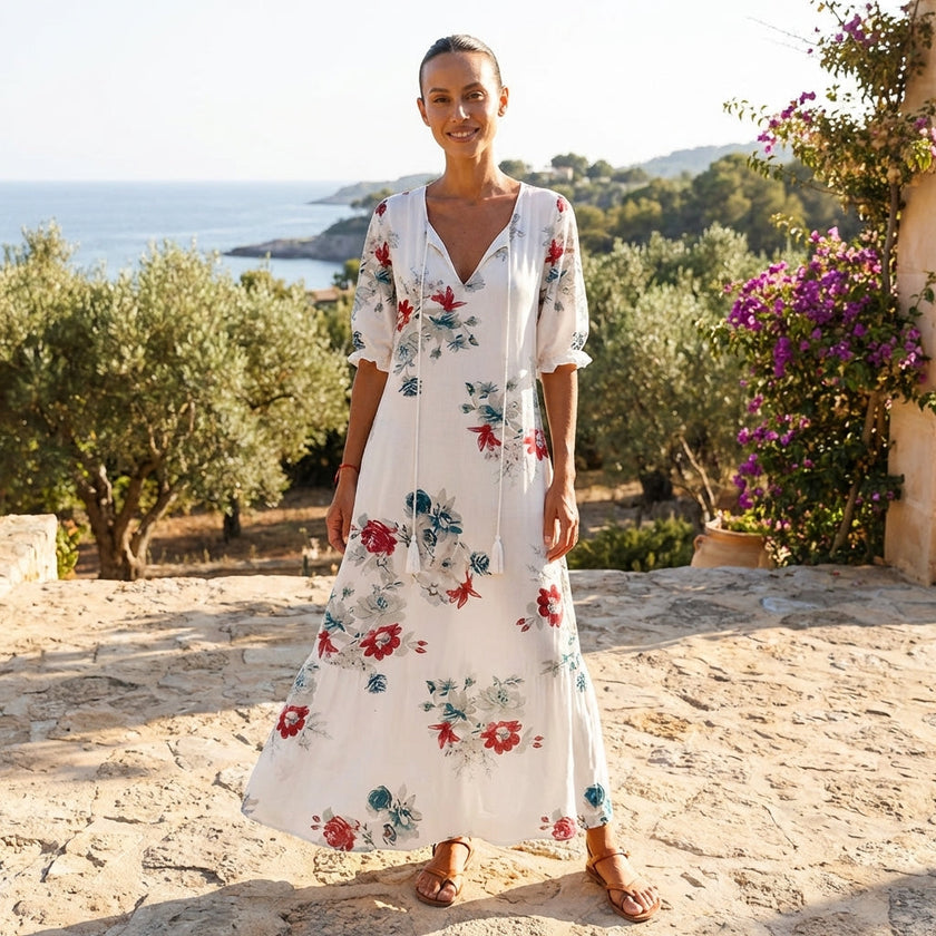 FJØRNA floral V-neck maxi dress with short sleeves, flowy fit, and vibrant floral pattern, perfect for summer or casual wear.