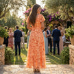 FJØRNA floral chiffon midi dress with short sleeves and flowy skirt, featuring a vibrant floral pattern and elegant silhouette.