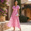FJØRNA floral chiffon midi dress with short sleeves and a flowy skirt, perfect for elegant spring or summer occasions.