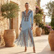 FJØRNA embroidered fringe midi dress with deep V neckline, featuring intricate embroidery and flowing fringe details.