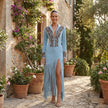 FJØRNA embroidered fringe midi dress with deep V neckline, featuring intricate embroidery and flowing fringe details.