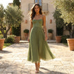 Elegant FJØRNA pleated midi dress with a flowy silhouette, featuring soft fabric and a stylish, sophisticated design.