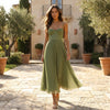 Elegant FJØRNA pleated midi dress with a flowy silhouette, featuring soft fabric and a stylish, sophisticated design.